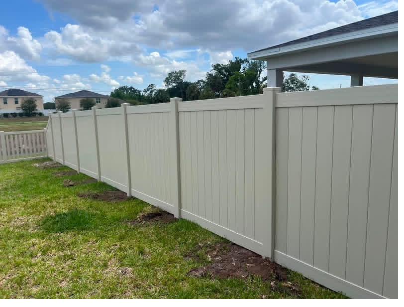 Tan vinyl privacy fence